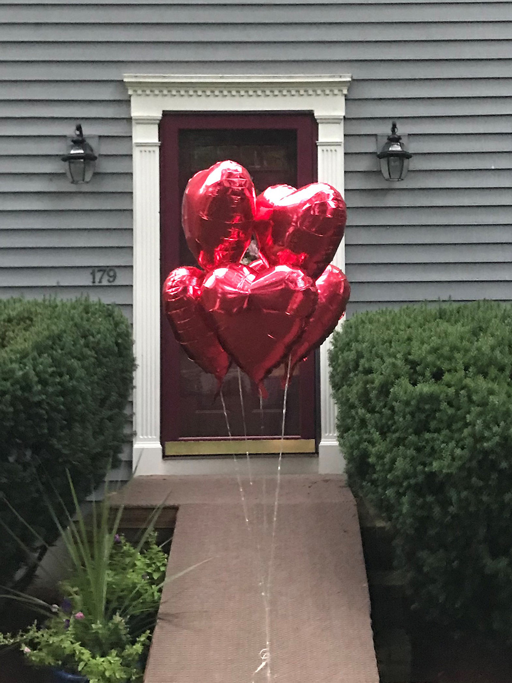 Photo of 5 memorial balloons left at parent's doorstep